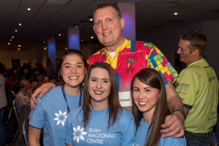 Doddie with Euan MacDonald Centre researchers (L-R) Rachel Kline, Alison Thomson and Natalie Courtney at the Centre’s fundraiser ‘Just a Sports Quiz’ in 2017.