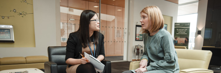 researcher discussing paperwork with a patient