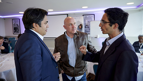 three meeting attendees in discussion