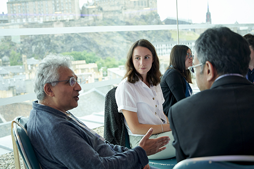 three meeting attendees in discussion